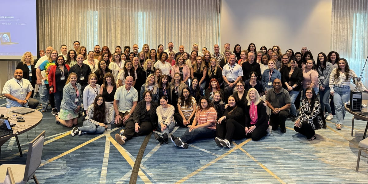 The DermCare Management team together at a company meeting.