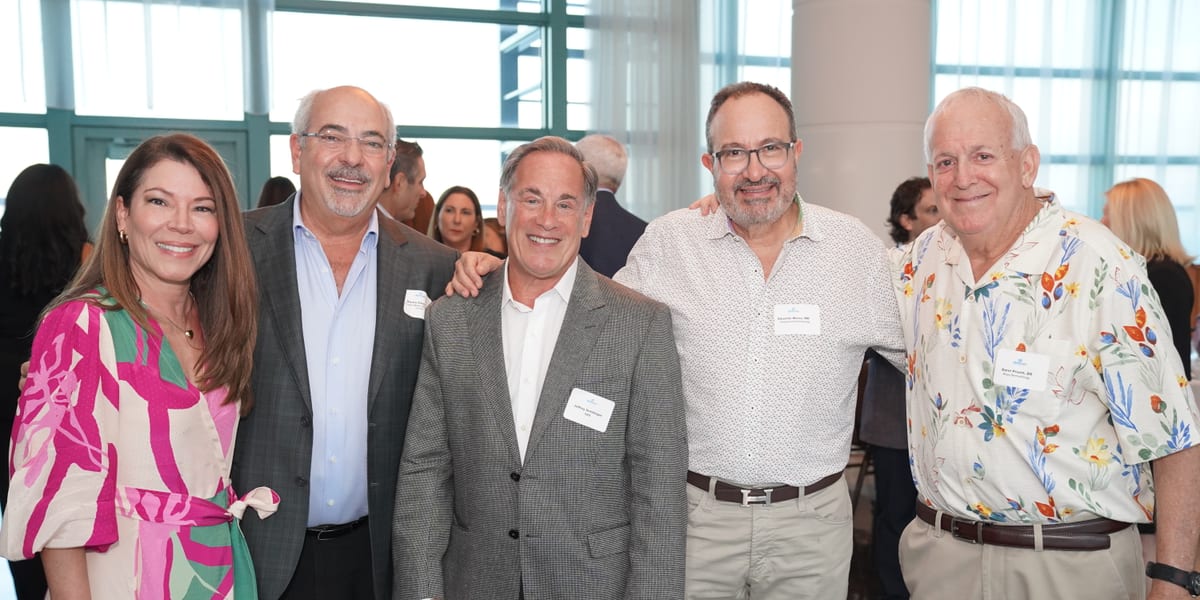 DermCare Management partner physicians and leadership together at a company event.